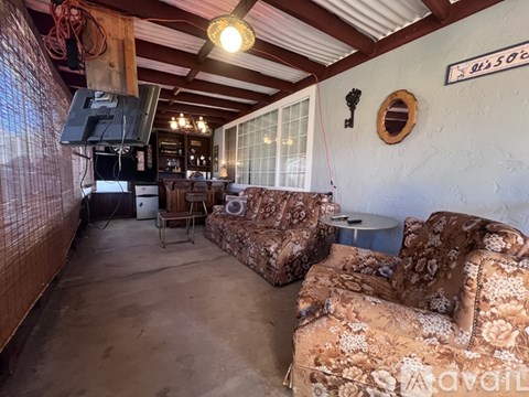 A living room with a sofa and a television.
