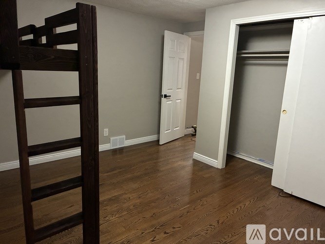 A room with a wooden floor and a white door.