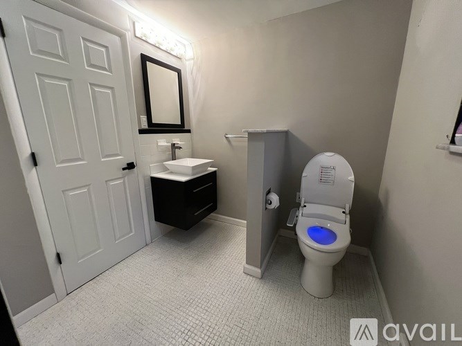 A bathroom with a toilet and sink.