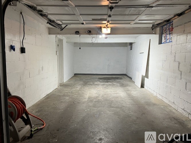 A spacious, empty room with white brick walls and a concrete floor.