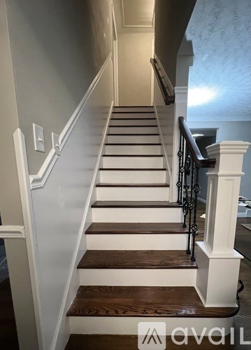 A staircase with white railings and wooden steps.