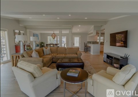 A living room with white furniture and a fireplace.