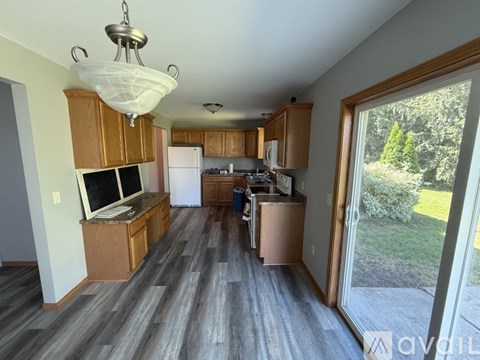 A kitchen with wooden cabinets and a white refrigerator.