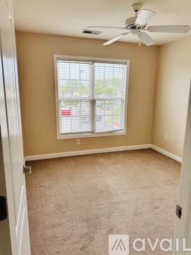 A room with a window and a ceiling fan.