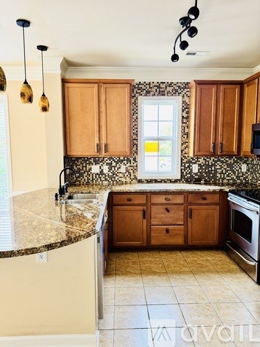 A kitchen with wooden cabinets and a granite countertop.