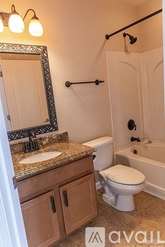 A bathroom with a sink, toilet, and bathtub.