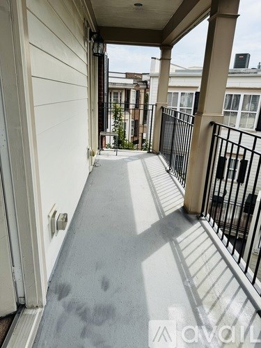 A balcony with a metal railing and a white door.
