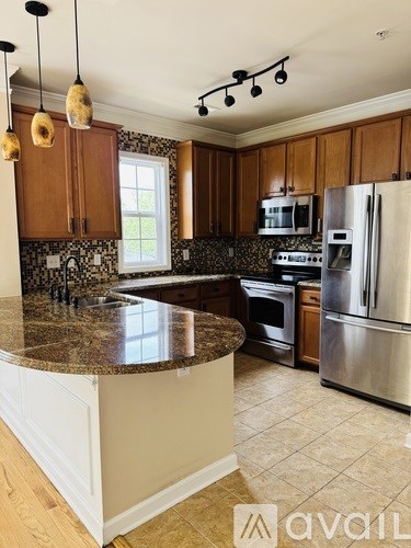 A kitchen with granite countertops and stainless steel appliances.