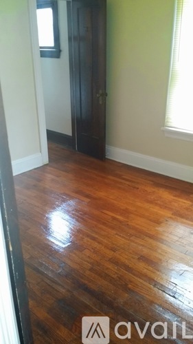 A room with a wooden floor and a door.