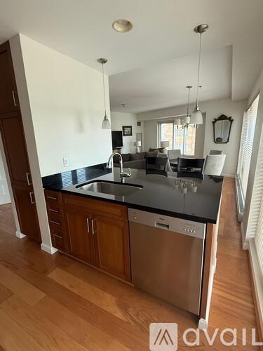 A kitchen with wooden cabinets and a black countertop.