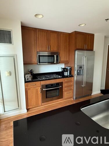 A kitchen with wooden cabinets and stainless steel appliances.