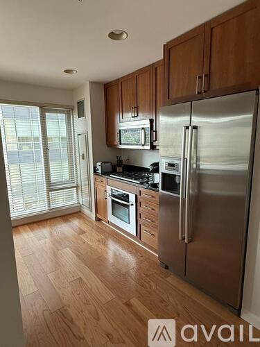 A kitchen with wooden cabinets and stainless steel appliances.