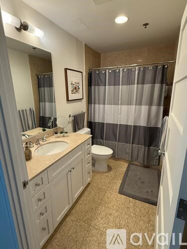 A bathroom with a sink, toilet, and shower.