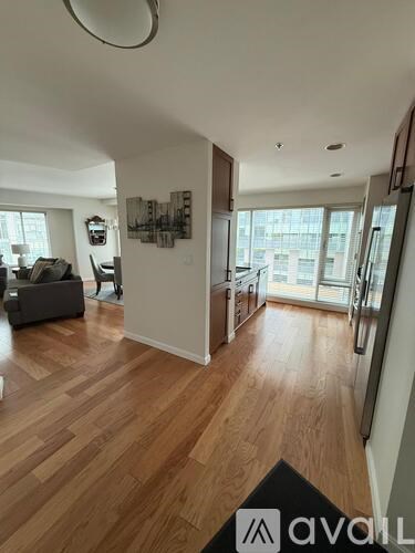 A living room with wood flooring and a couch.