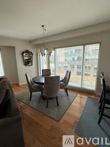 A dining room with a table and chairs.