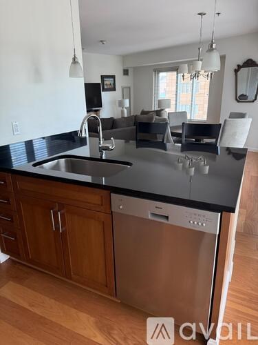 A kitchen with a black countertop and wooden cabinets.