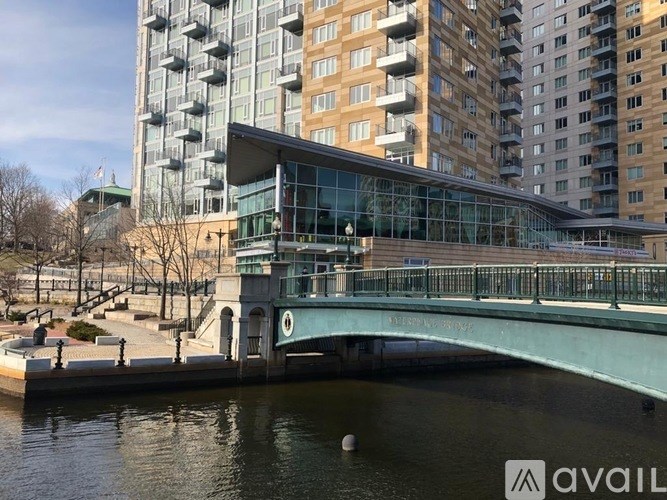 A bridge over a body of water with buildings in the background.