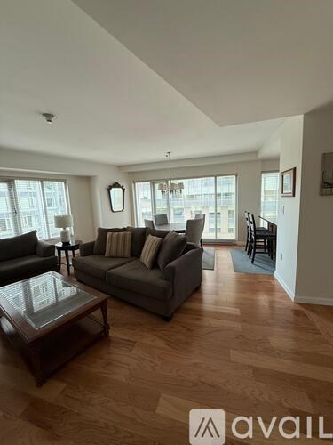 A living room with a couch, chairs, and a coffee table.