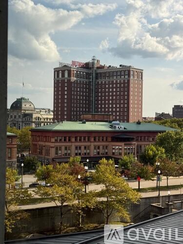 A view of a cityscape with a large building in the center.