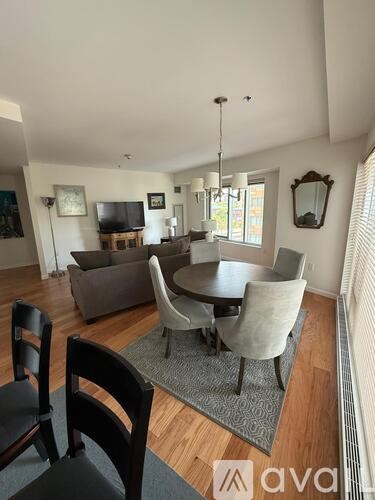 A dining room with a table and chairs.