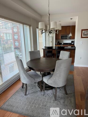 A dining room with a table and chairs.