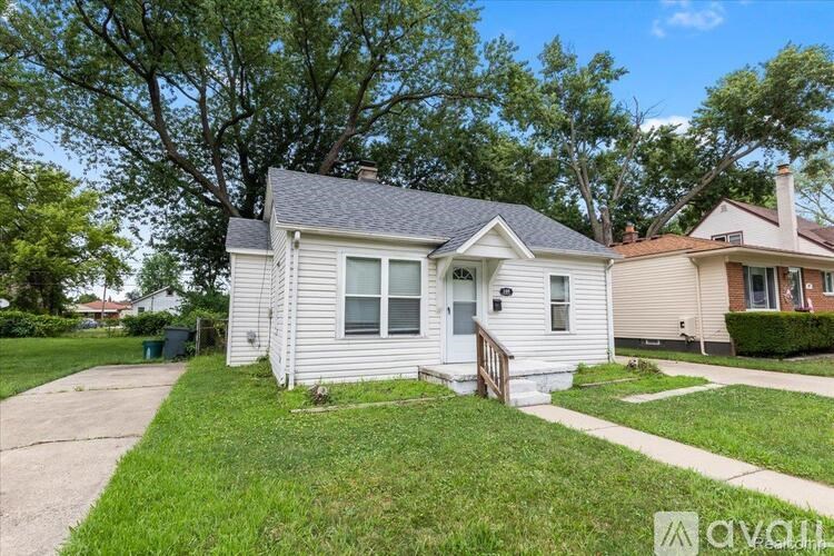 A house with a front yard and a driveway.