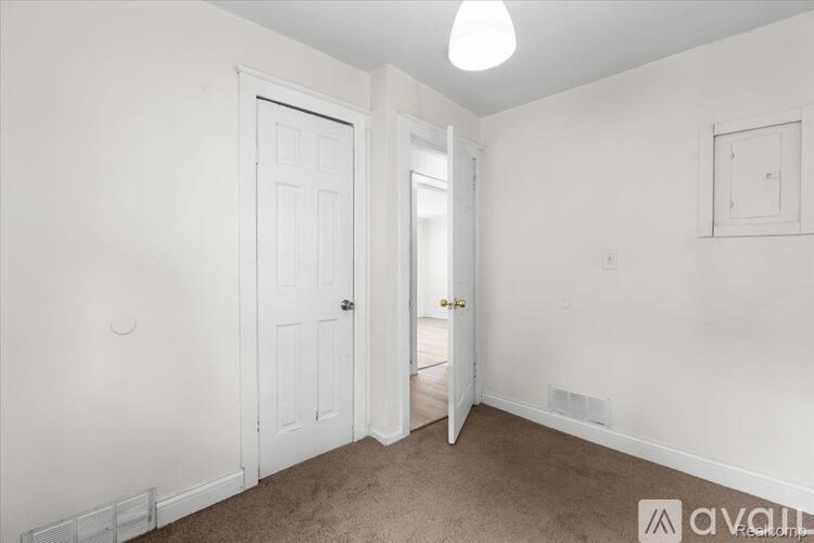 A room with a white door and a window.