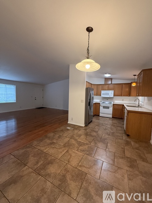 A house with a white door and windows is available for rent.