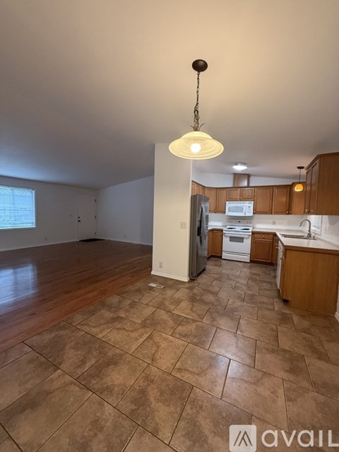 A house with a white door and windows is available for rent.