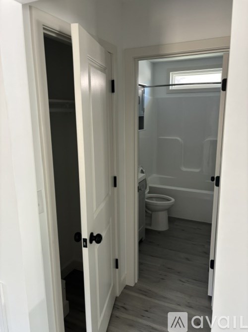 A bathroom with a toilet and a shower.