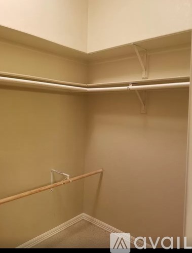 A room with a white ceiling and a beige wall.