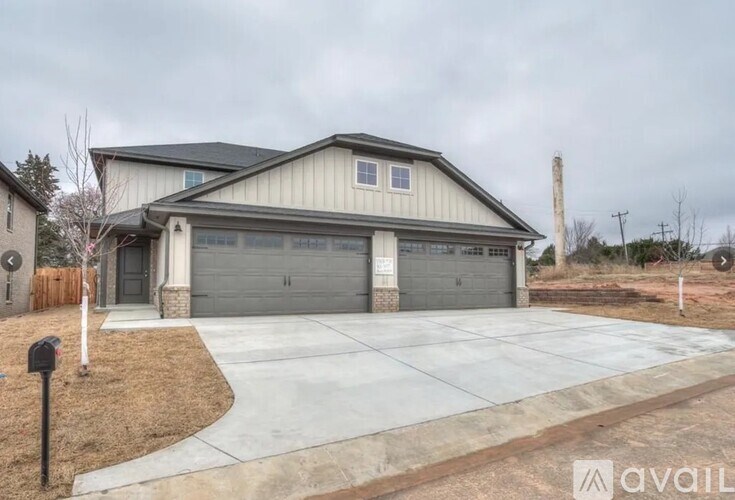 A house with a grey roof and a grey garage door is available for sale.