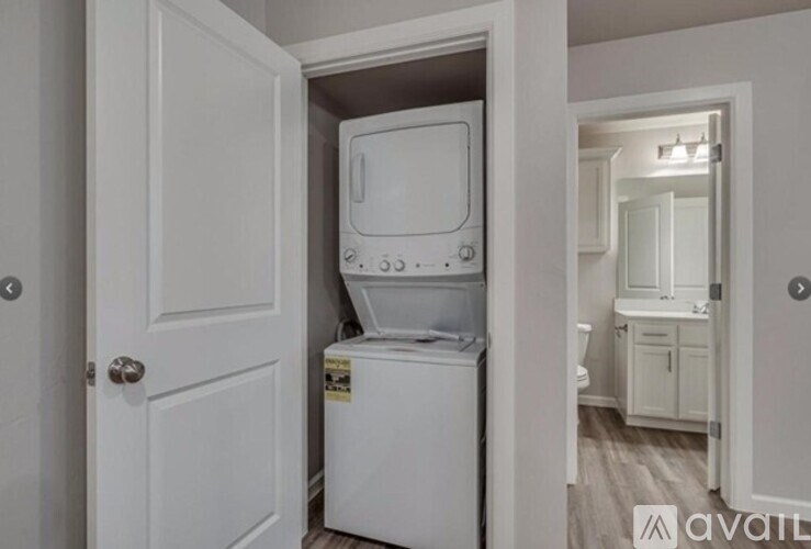 A white washing machine is in a small room.