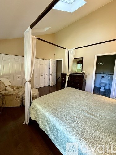 Bedroom with a bed, a couch, and a dresser.