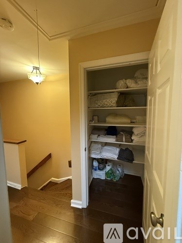 A laundry room with a door open to a hallway.