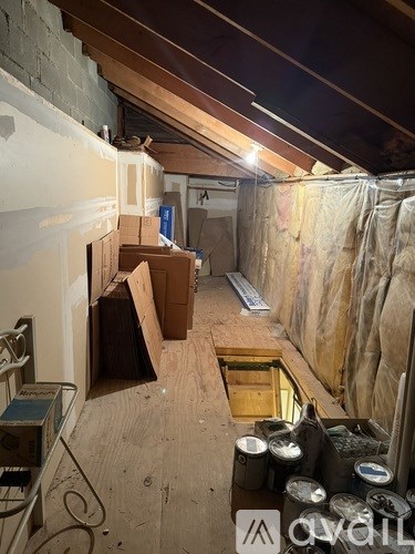 A room under construction with unfinished walls and a hole in the floor.