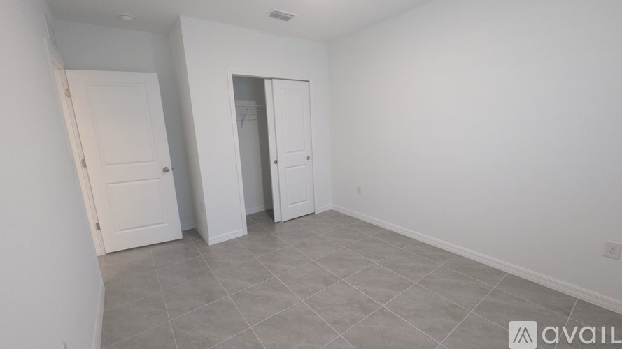 A room with two doors and a tiled floor.