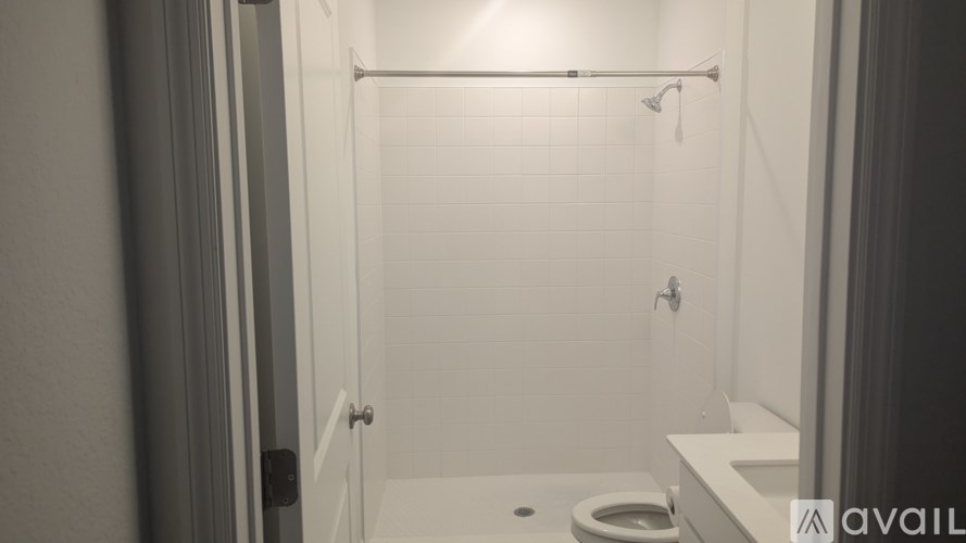 A bathroom with a toilet and a shower.