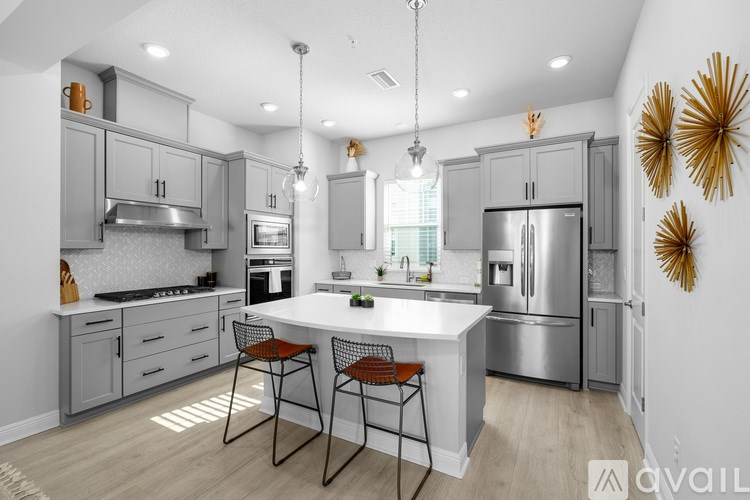 A row of modern townhouses with garages.