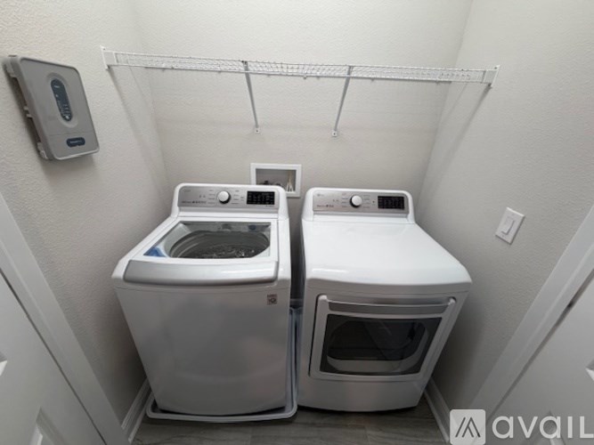 A small laundry room with a washer and dryer.
