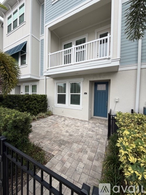 A house with a blue door and a small patio.
