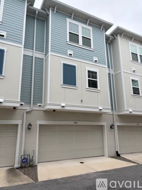A row of houses with garages and the number 14 visible.