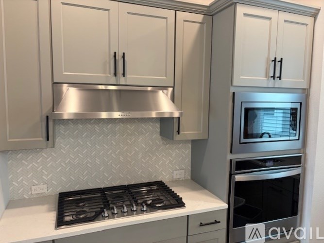 A kitchen with a stove top oven and a microwave.