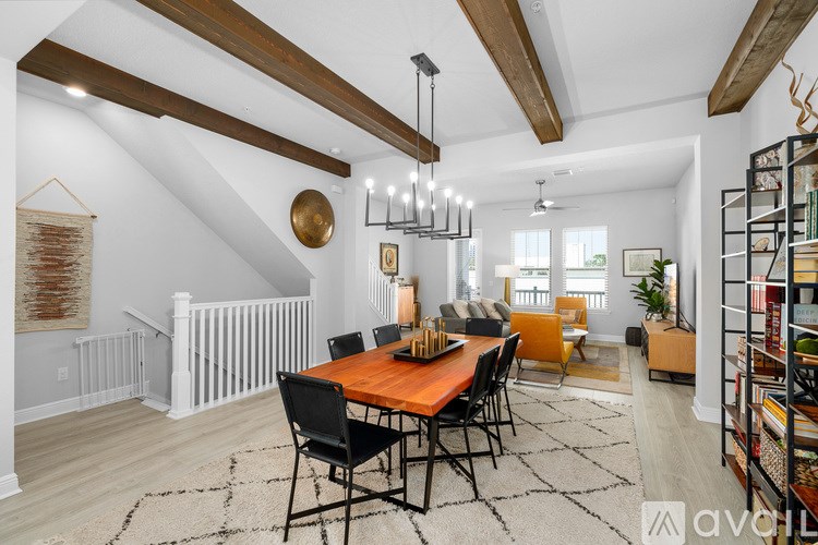 A dining room with a wooden table and chairs.
