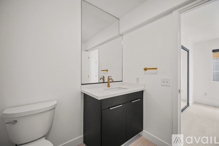 A bathroom with a white tub and a black cabinet with a sink.