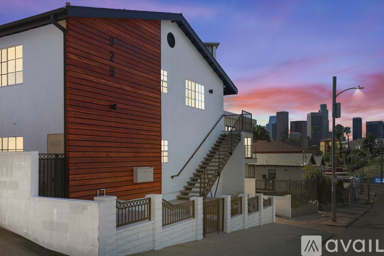 A modern house with a wooden facade and a staircase leading to the entrance.