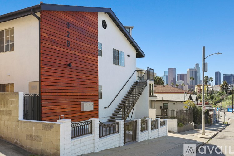 A modern house with a wooden facade is for sale.