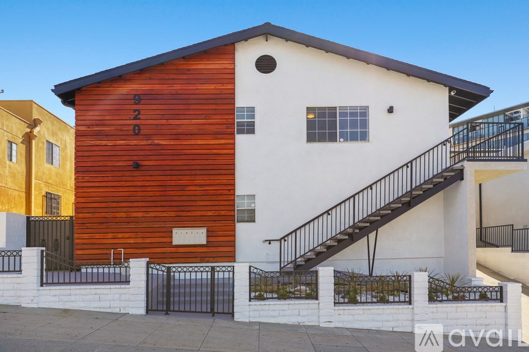 A modern house with a wooden facade and a white exterior.