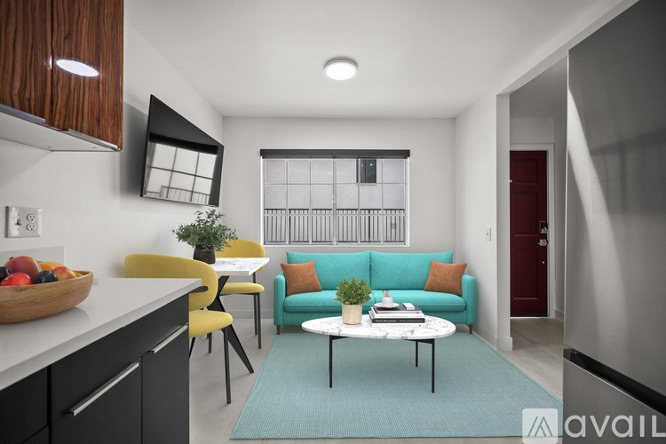 A modern kitchen with a dining area and a living room.