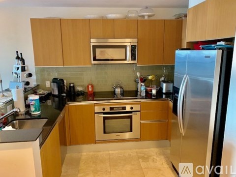 A kitchen with wooden cabinets and stainless steel appliances.